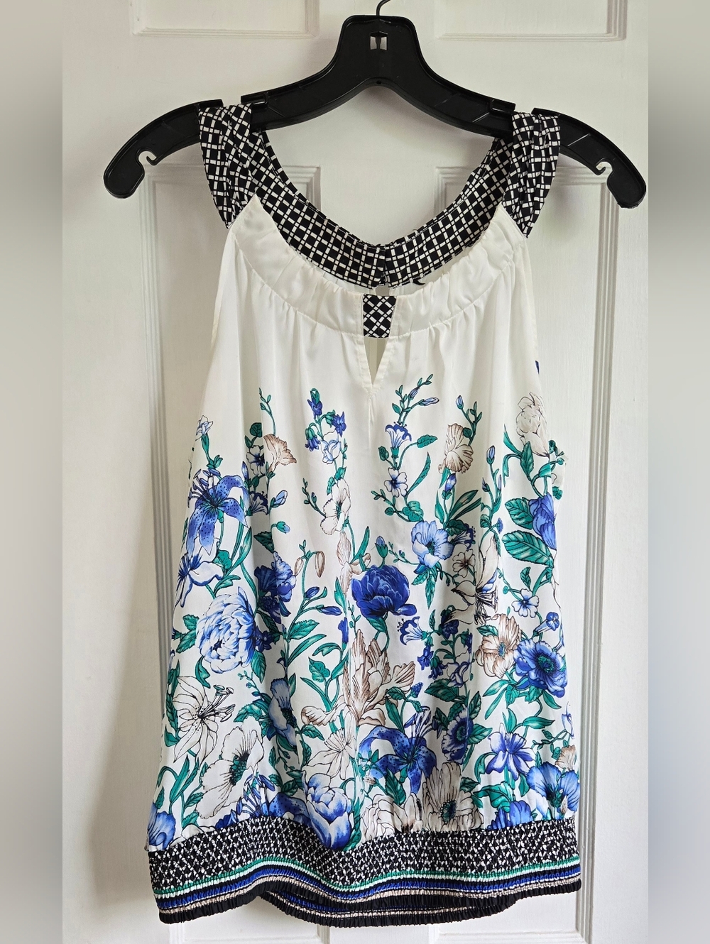 Floral Sleeveless Top With Ruched Band At Bottom In White and Blue.